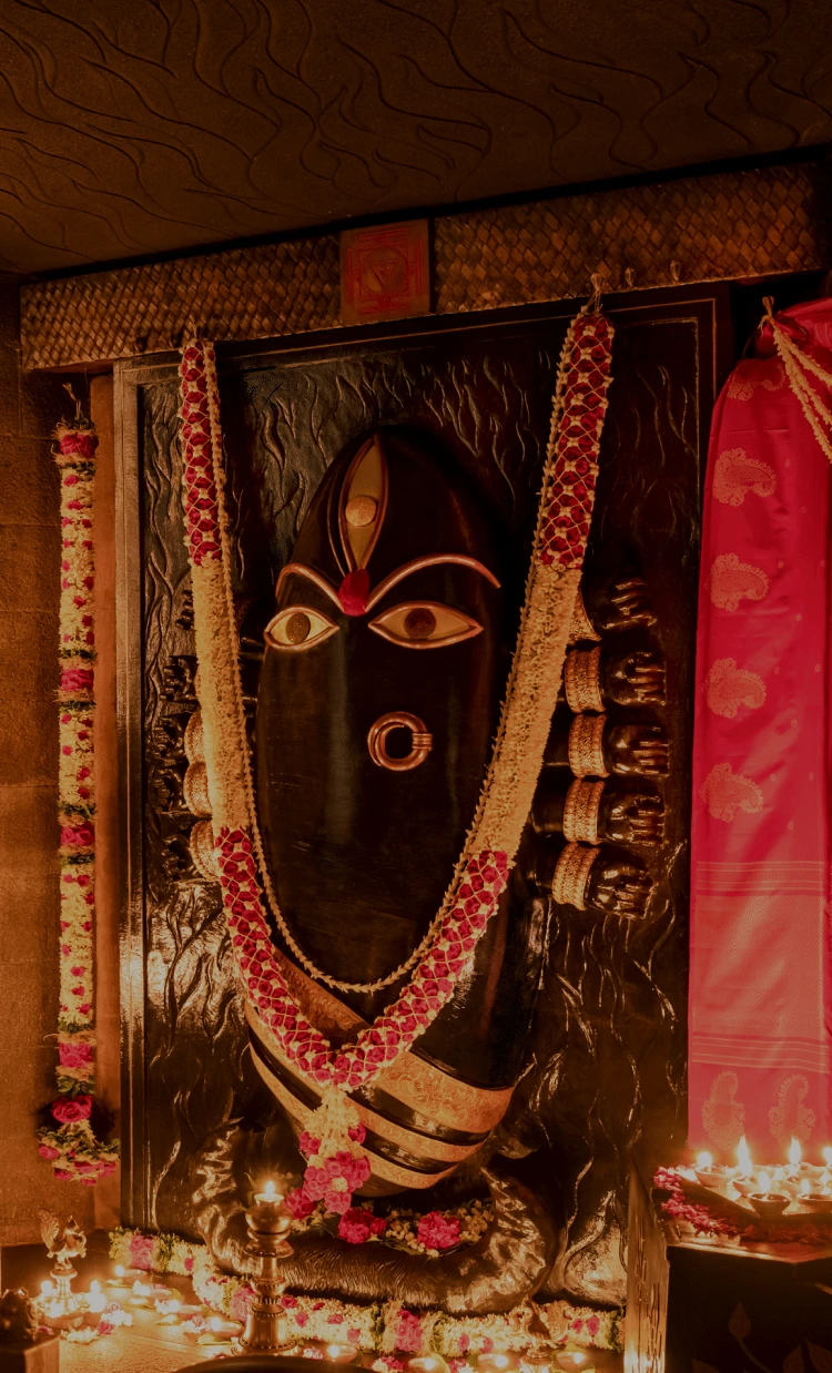 Linga Bhairavi in her dark form, surrounded by garlands and lamps