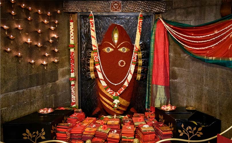 Linga Bhairavi adorned in red with flower garlands